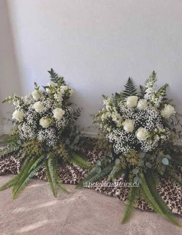 White rose, baby’s breath and fern wedding bouquets with white ribbon