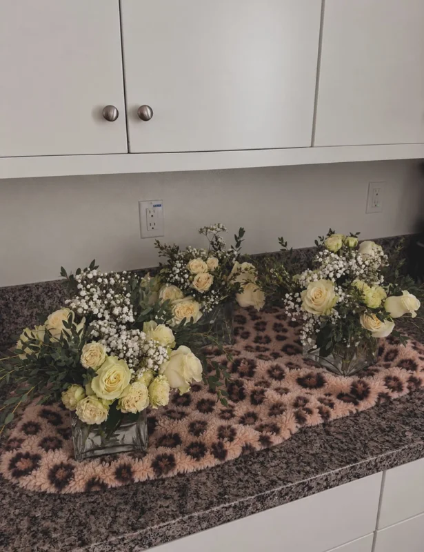 Coordinated white rose and baby’s breath wedding bouquets with greenery
