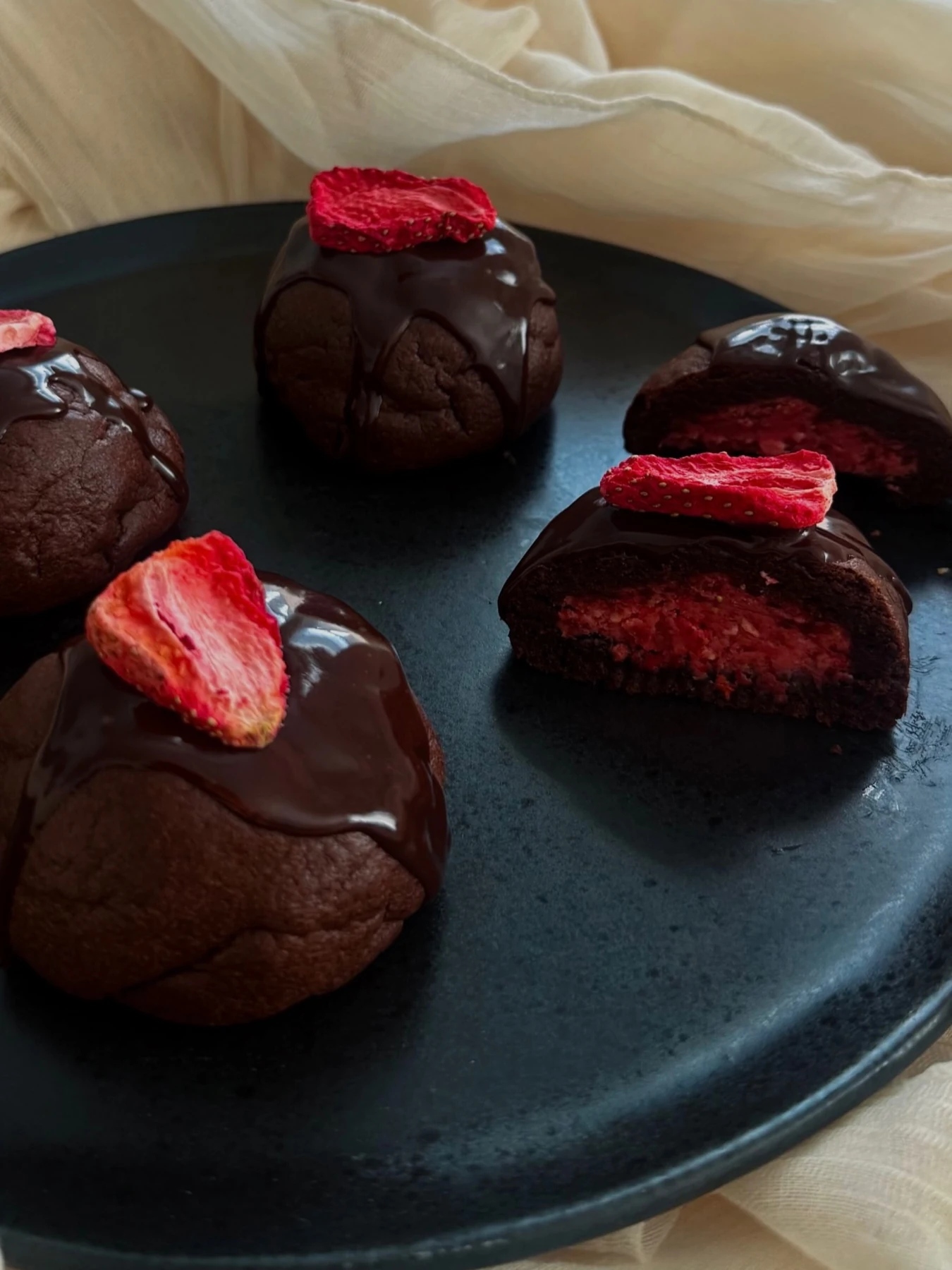 Chocolate cookies with strawberry centers and chocolate glaze